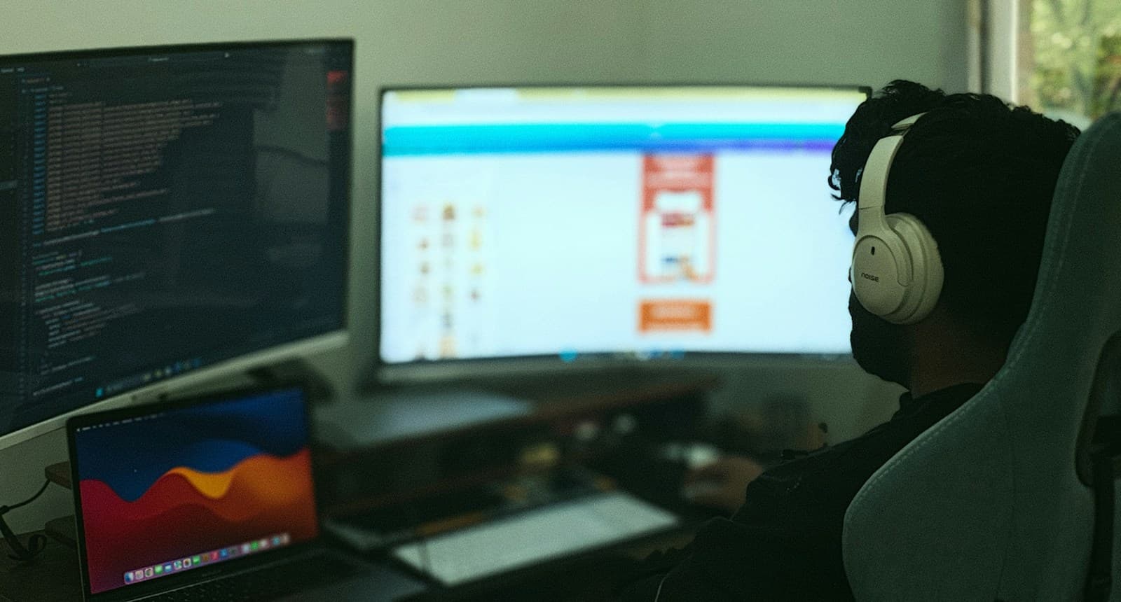 Developer working across several monitors