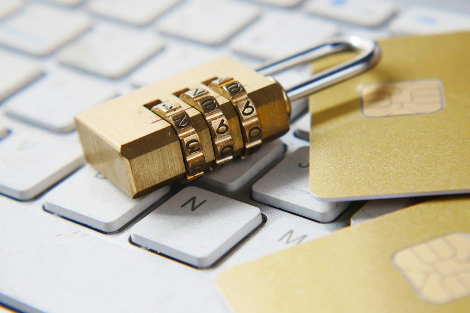 Padlock on a keyboard next to bank cards