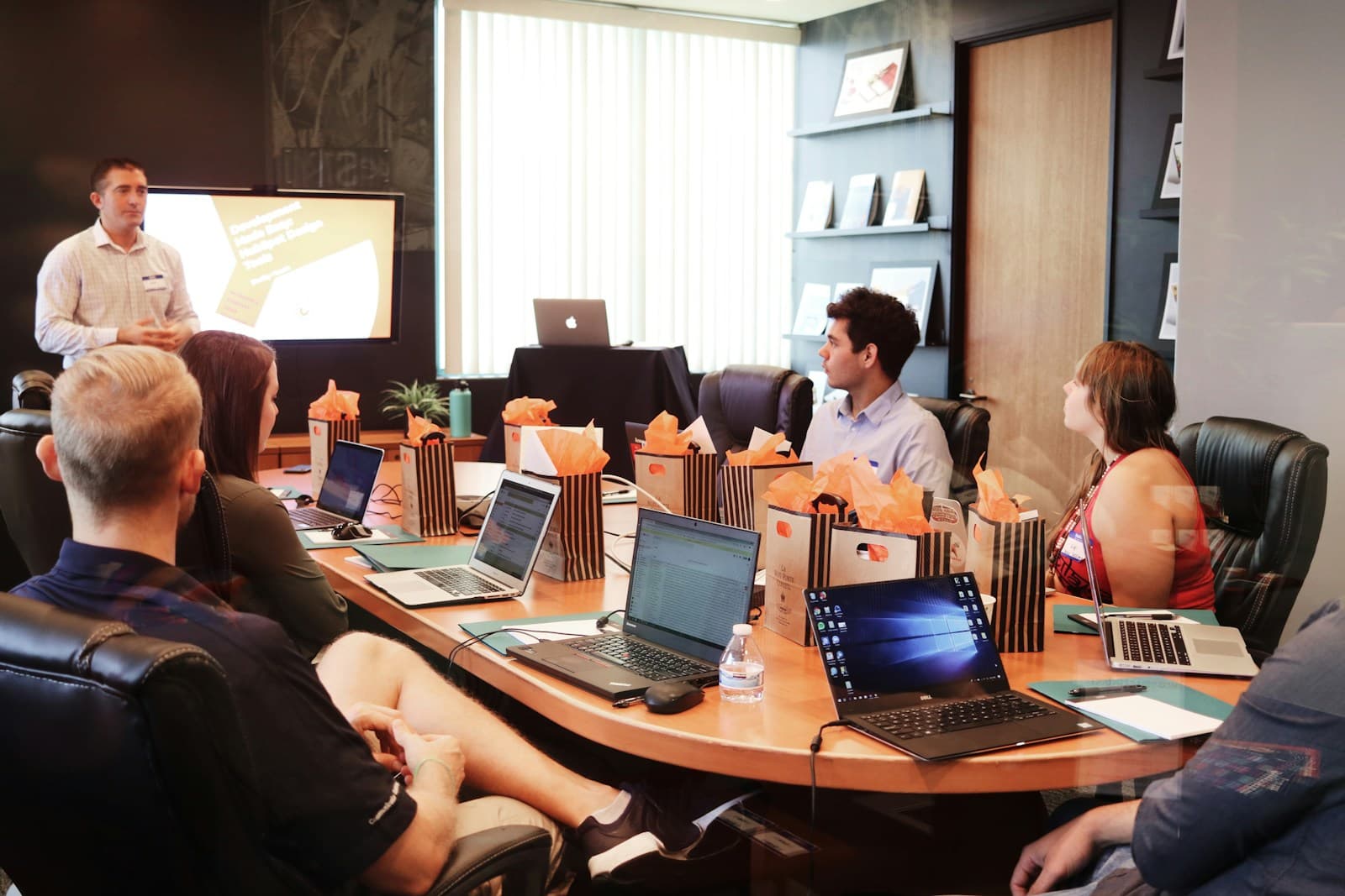 Team meeting around a table with laptops