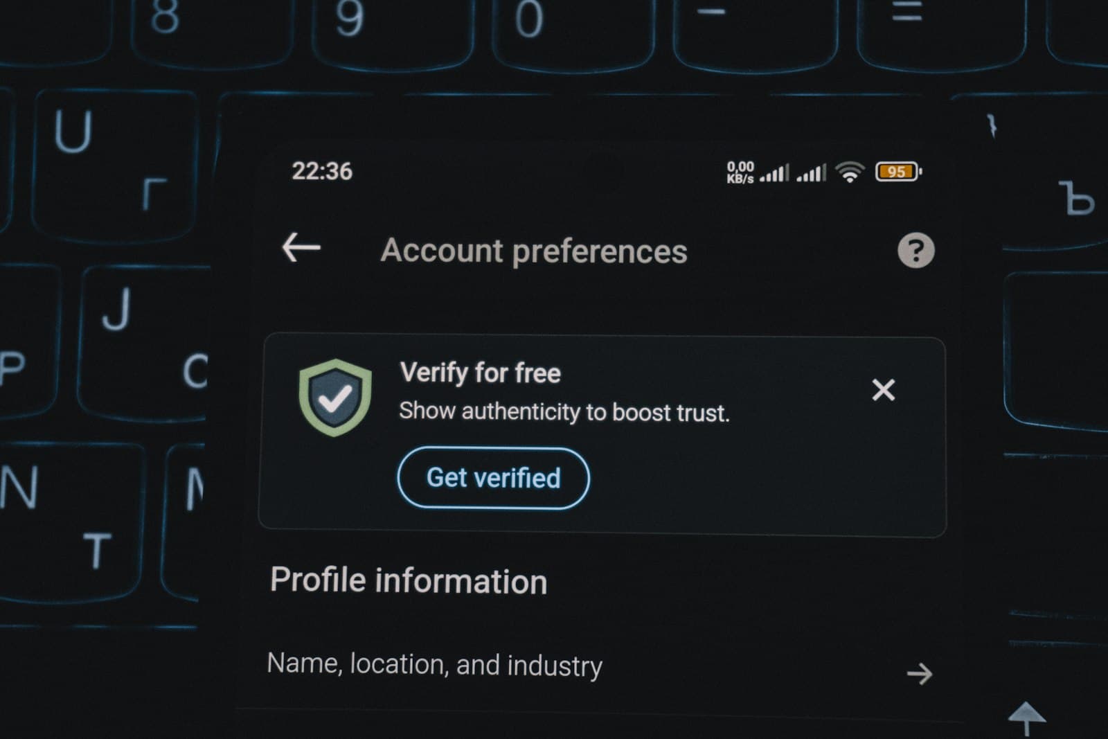 Account security screen on a phone above a keyboard